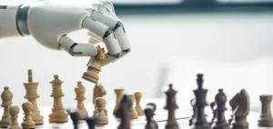 Mano robotica che sposta un cavallo su una scacchiera: le scelte strategiche sull’intelligenza artificiale in azienda